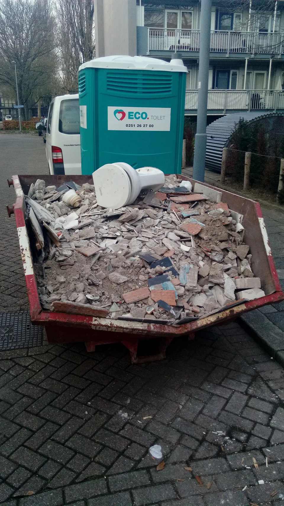 Évacuation de gravats devant un immeuble en rénovation